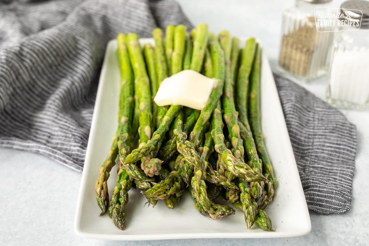 Front view of Sweet Sautéed Asparagus tips with melting butter on top.