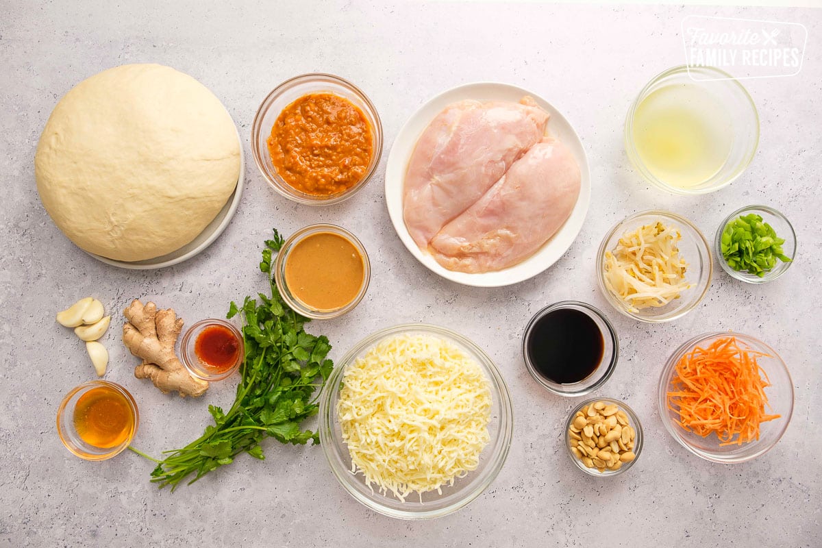 Ingredients in individual bowls for Thai chicken pizza. 