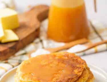 Yogurt Pancakes on Plate with Syrup and Butter behind