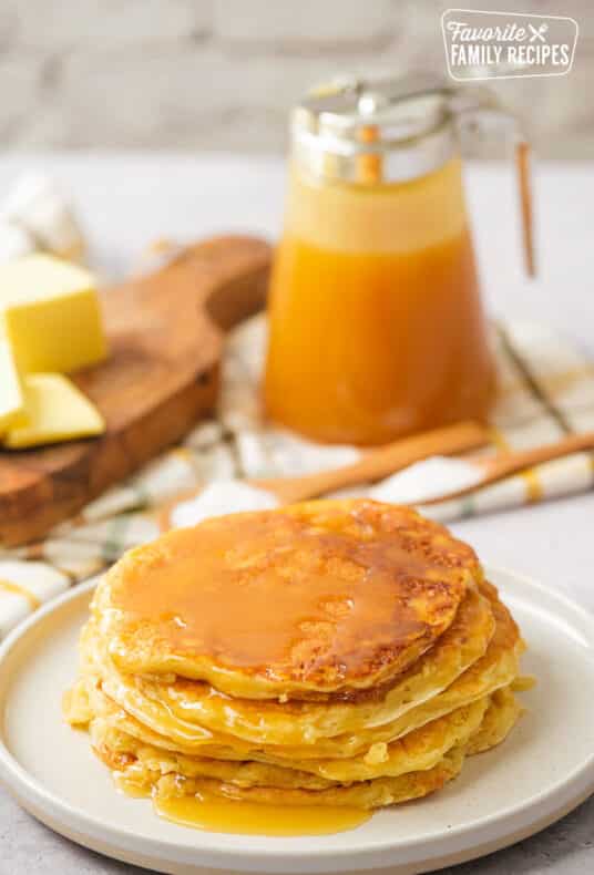 Yogurt Pancakes on Plate with Syrup and Butter behind