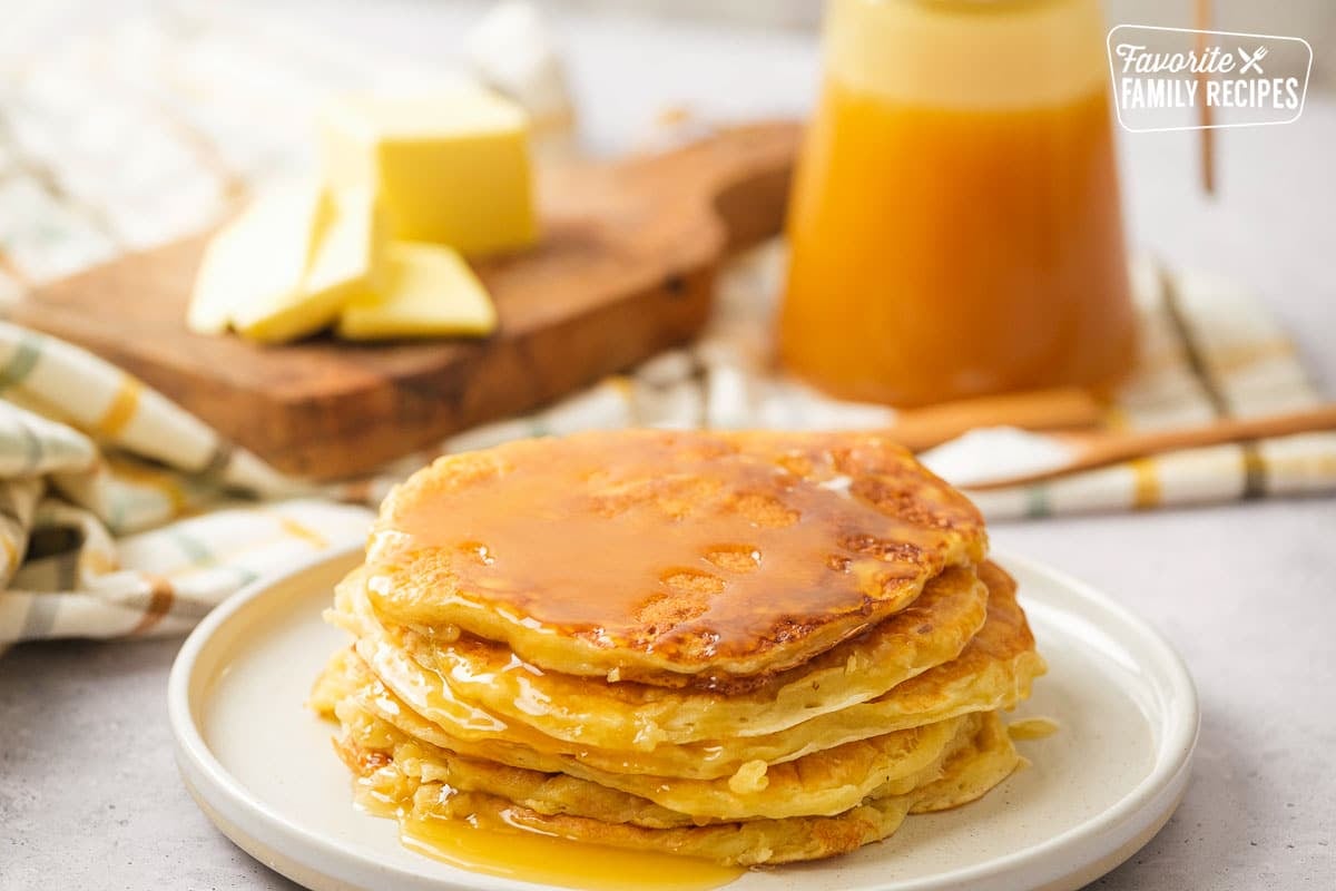 A stack of yogurt pancakes on a white plate. 