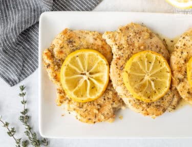 Plate with three Baked Lemon Chicken.