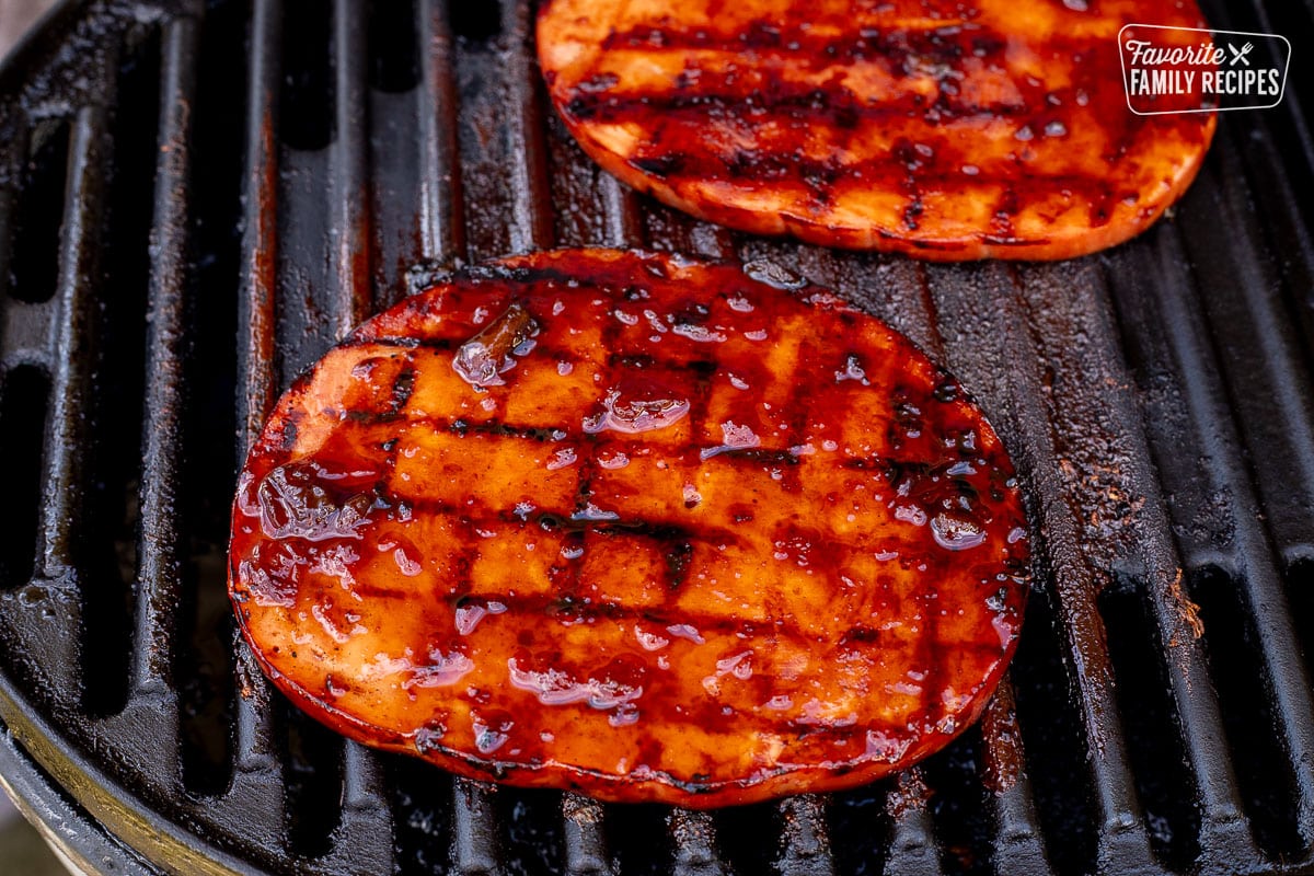 Ham steaks glazed with teriyaki sauce on the barbecue.