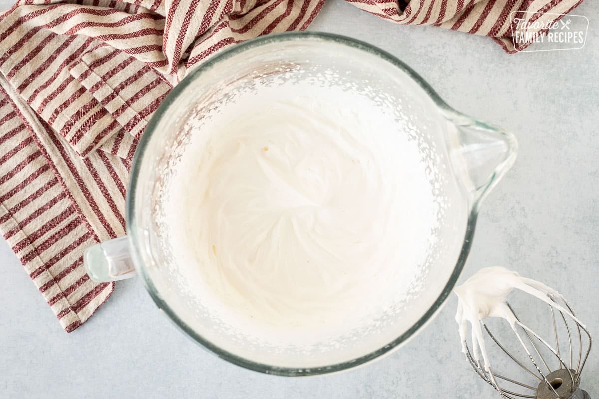 Whipped heavy cream in a glass bowl.