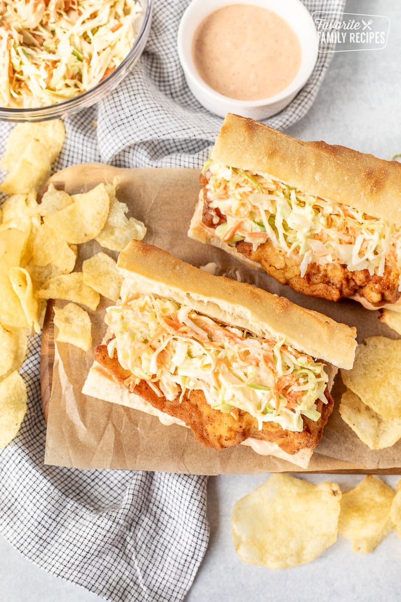 Two Cajun Fried Chicken Po'Boys with coleslaw and chips.
