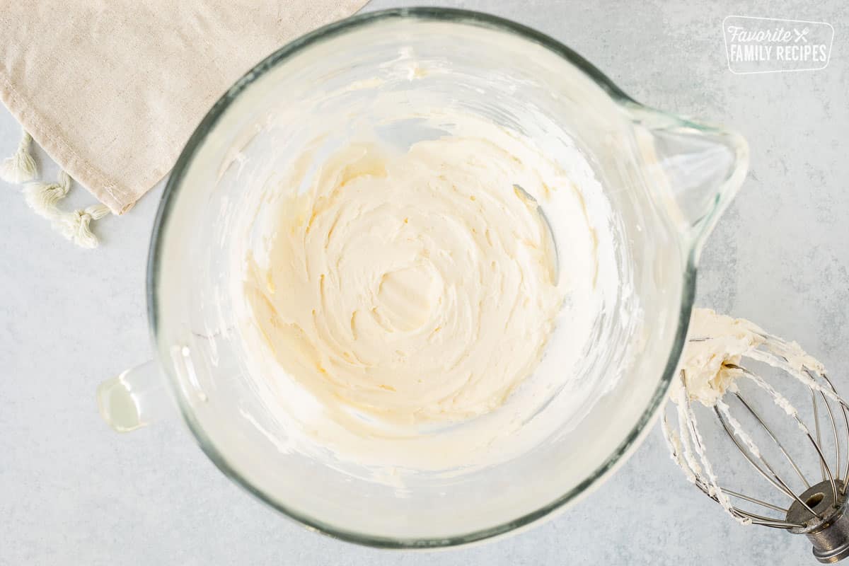 Glass mixing bowl with whipped butter and cream cheese.