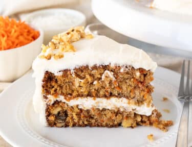 Classic Carrot Cake sliced on a plate with a fork.