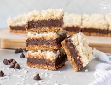 Four stacked Coconut Fudge Cookie Bars.