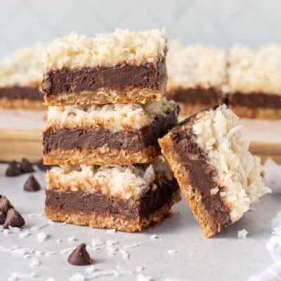 Four stacked Coconut Fudge Cookie Bars.