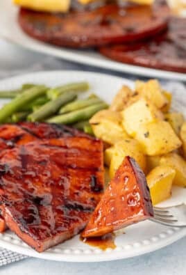 Cut piece of sweet teriyaki ham steak on a fork.