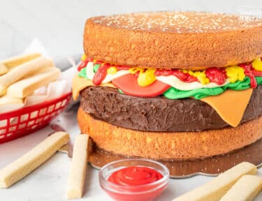 Full Hamburger Cake made from cake, fondant and frosting. Cookie fries on the side.