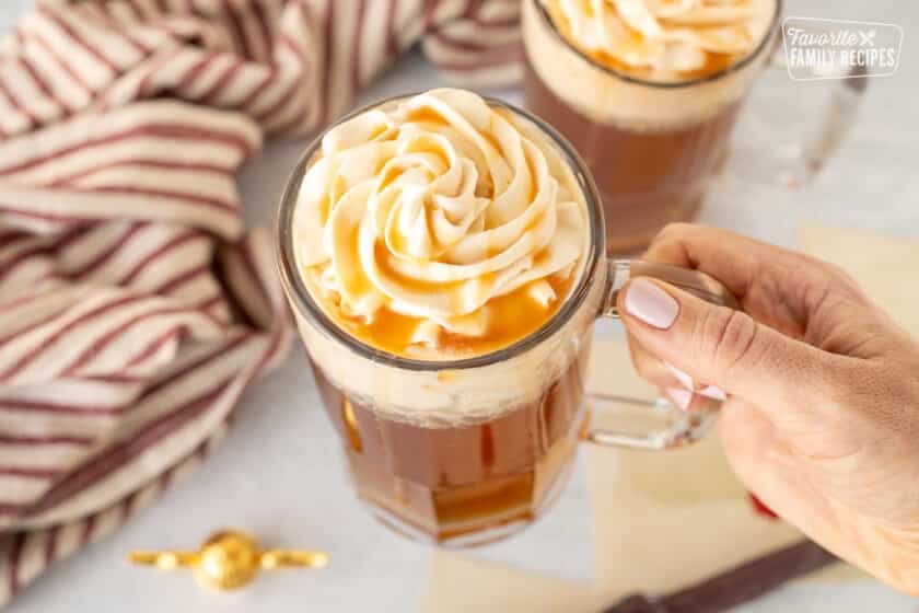 A glass of Butterbeer with butterscotch whipped topping.