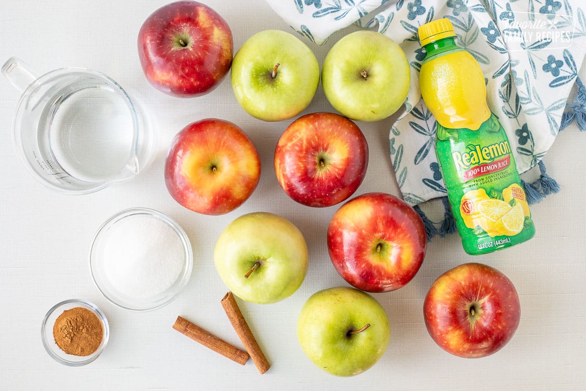 Ingredients to make Instant Pot Applesauce including apples, cinnamon, water, sugar and lemon juice.