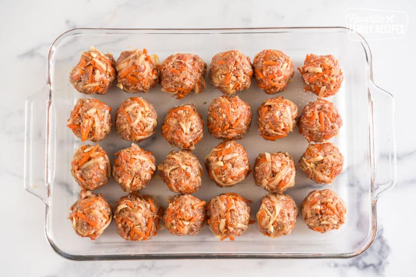 Meatballs rolled in a baking dish, unbaked