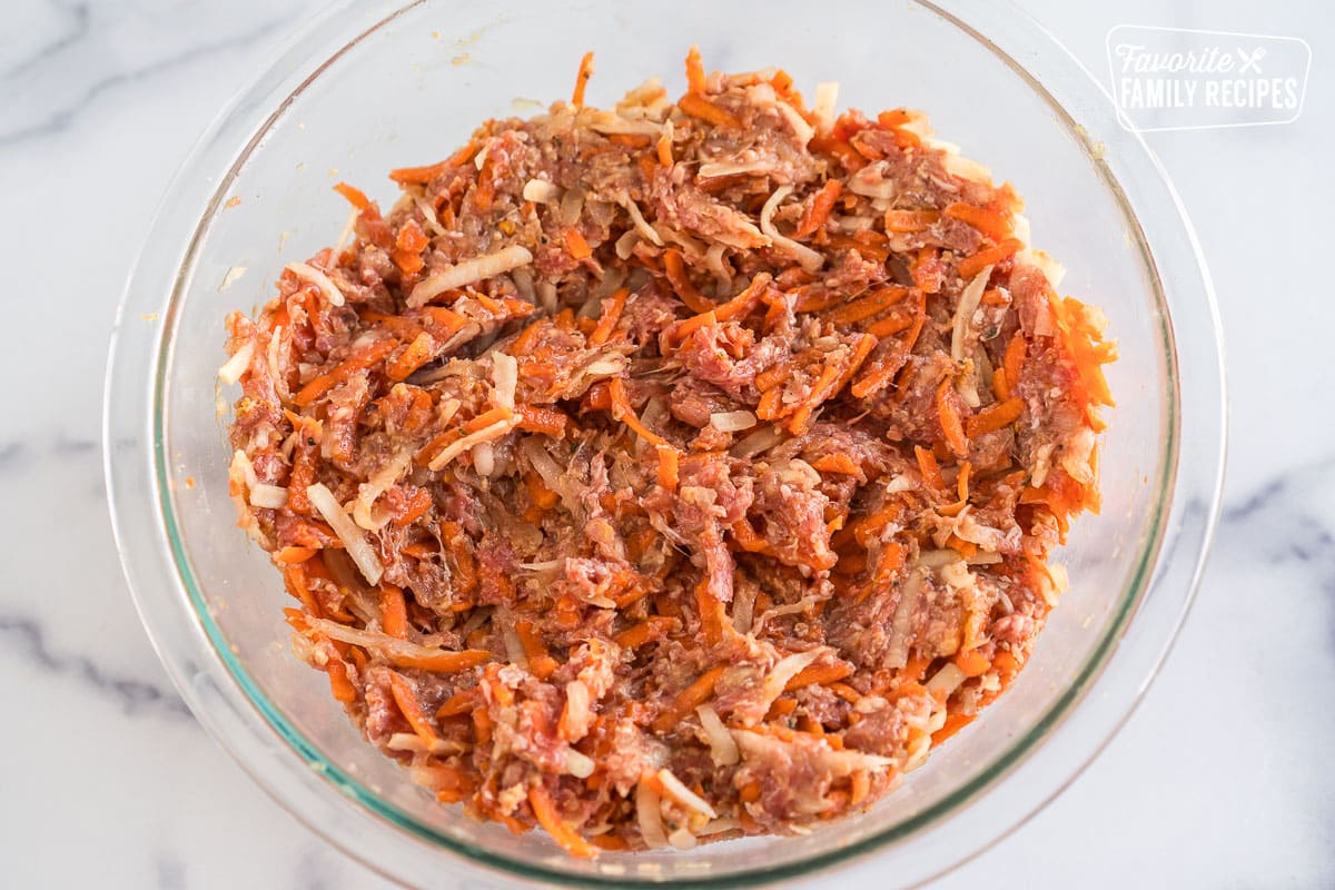 Ground beef, vegetables, and seasonings mixed in a bowl