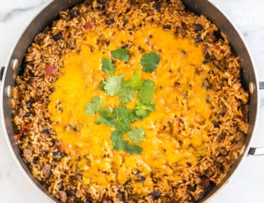 Mexican Beef and Rice Skillet topped with cheese and cilantro