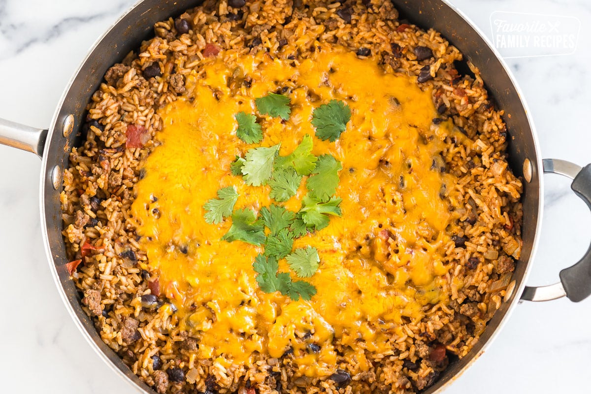 Mexican Beef and Rice Skillet topped with cheese and cilantro.