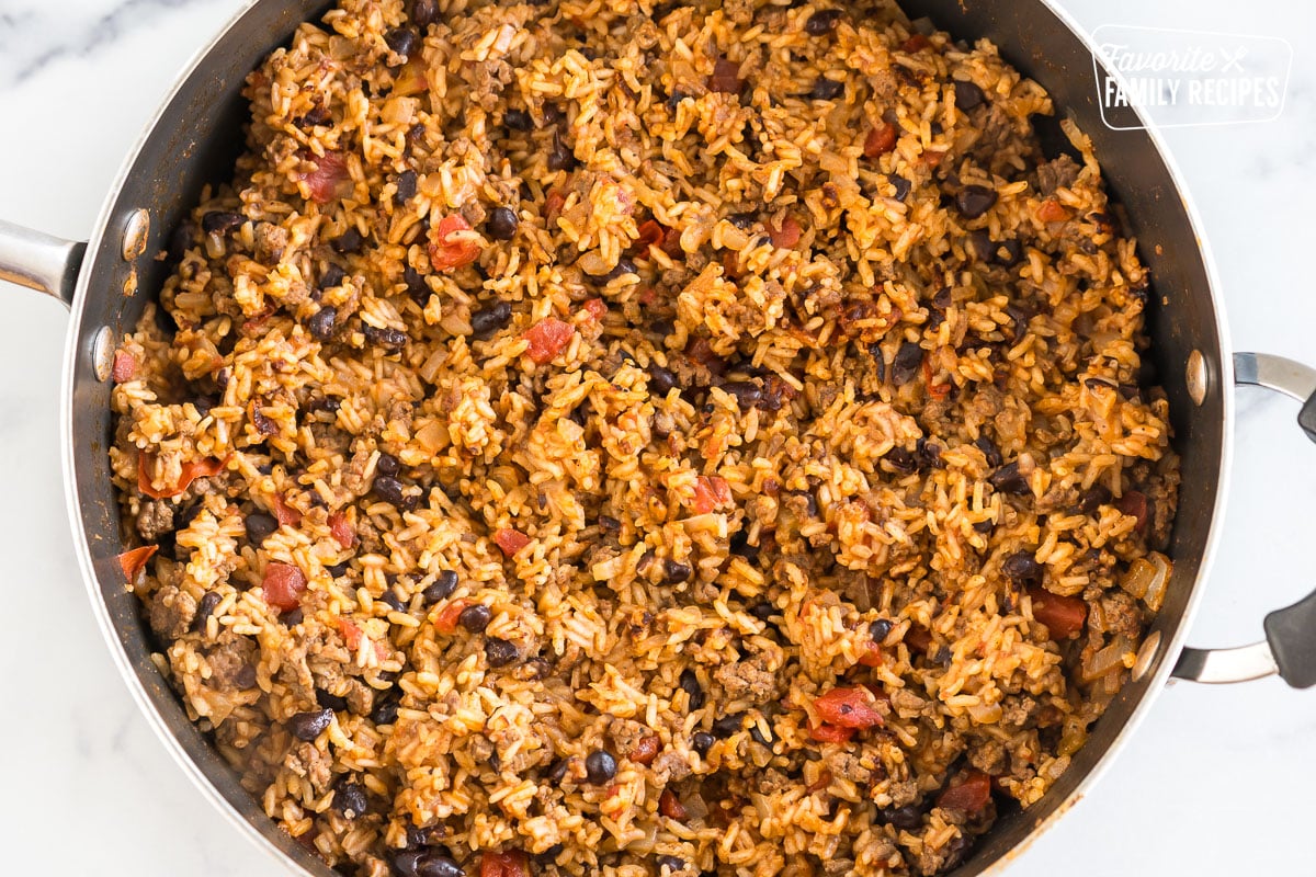 Rice, beef, beans, and tomatoes with spices in a skillet