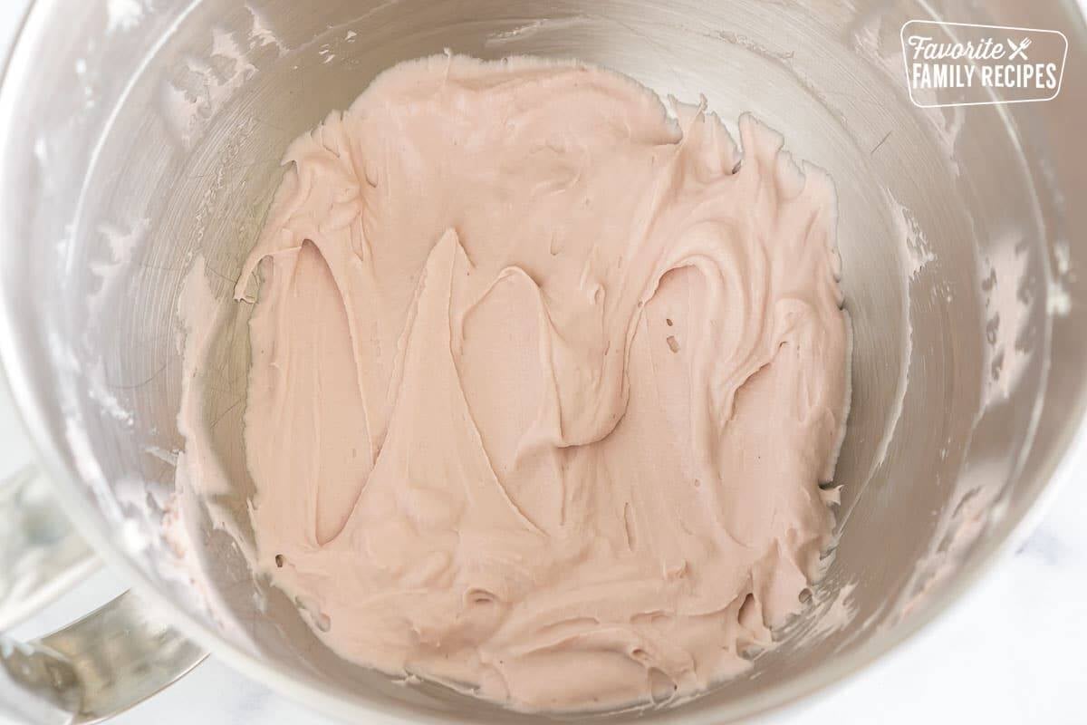 Butter, cream cheese, raspberry jam, and vanilla mixed in a mixing bowl