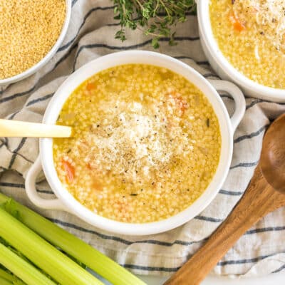 Pastina Soup in a bowl topped with cheese