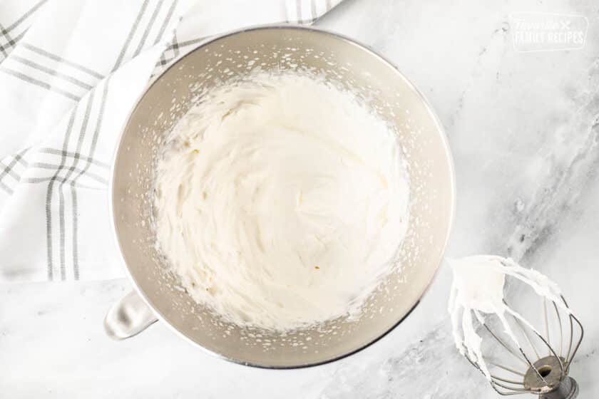 Mixing bowl with whipped cream. Whisk attachment on the side.