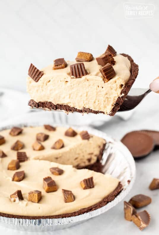 Holding up a slice of Peanut Butter Pie on a spatula.