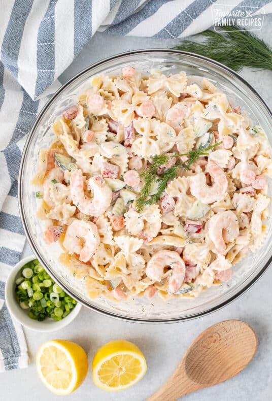 Bowl of Shrimp Pasta Salad with fresh dill, lemon and green onions.