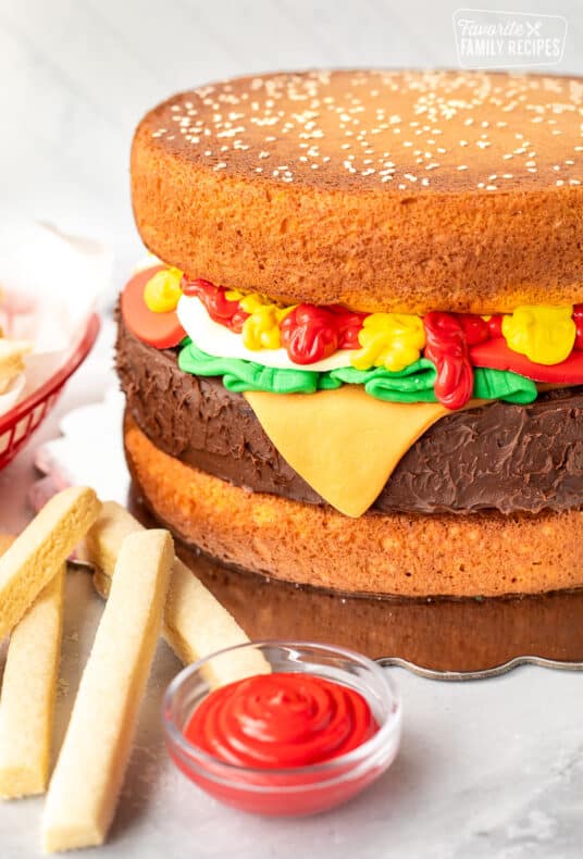 Decorated Hamburger Cake with cookie fries and red frosting to look like ketchup.