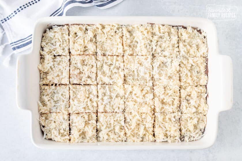 Cut Coconut Fudge Cookie Bars in a baking dish.