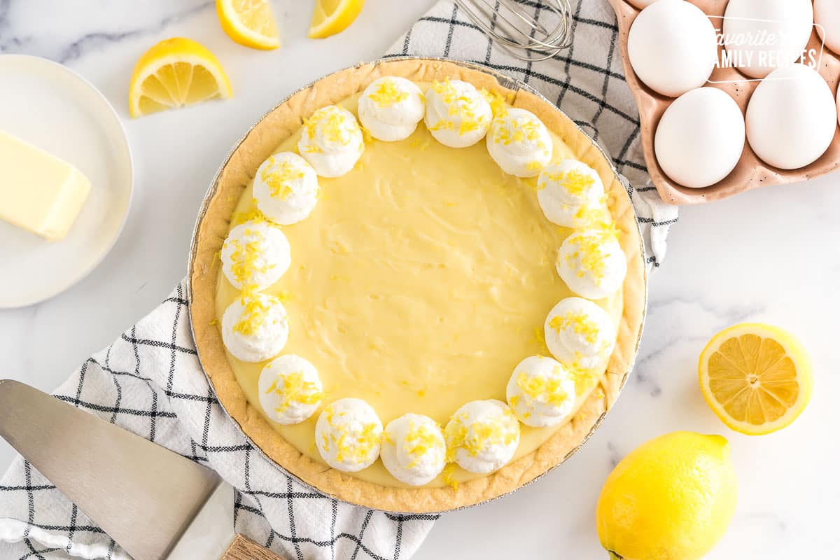 Sour Cream Lemon Pie topped with whipped cream and lemon zest