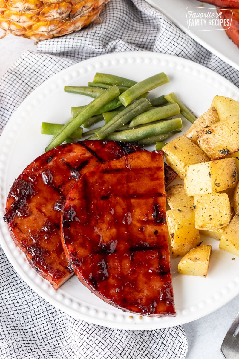 Barbecue sweet teriyaki ham steaks with green beans and potatoes.