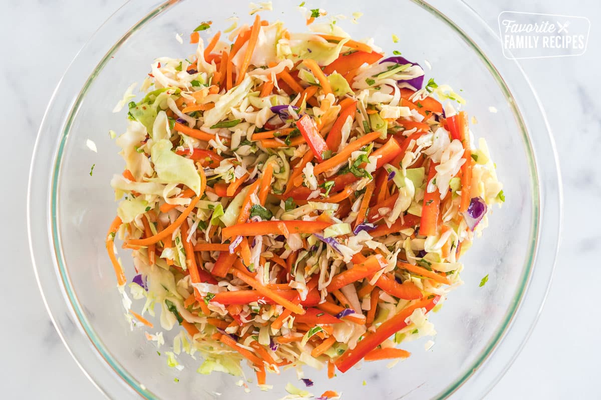 coleslaw with carrots and bell peppers in a bowl