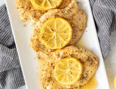 Three Baked Lemon Chicken Breasts on a dish.