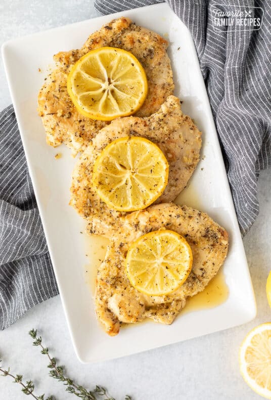 Three Baked Lemon Chicken Breasts on a dish.