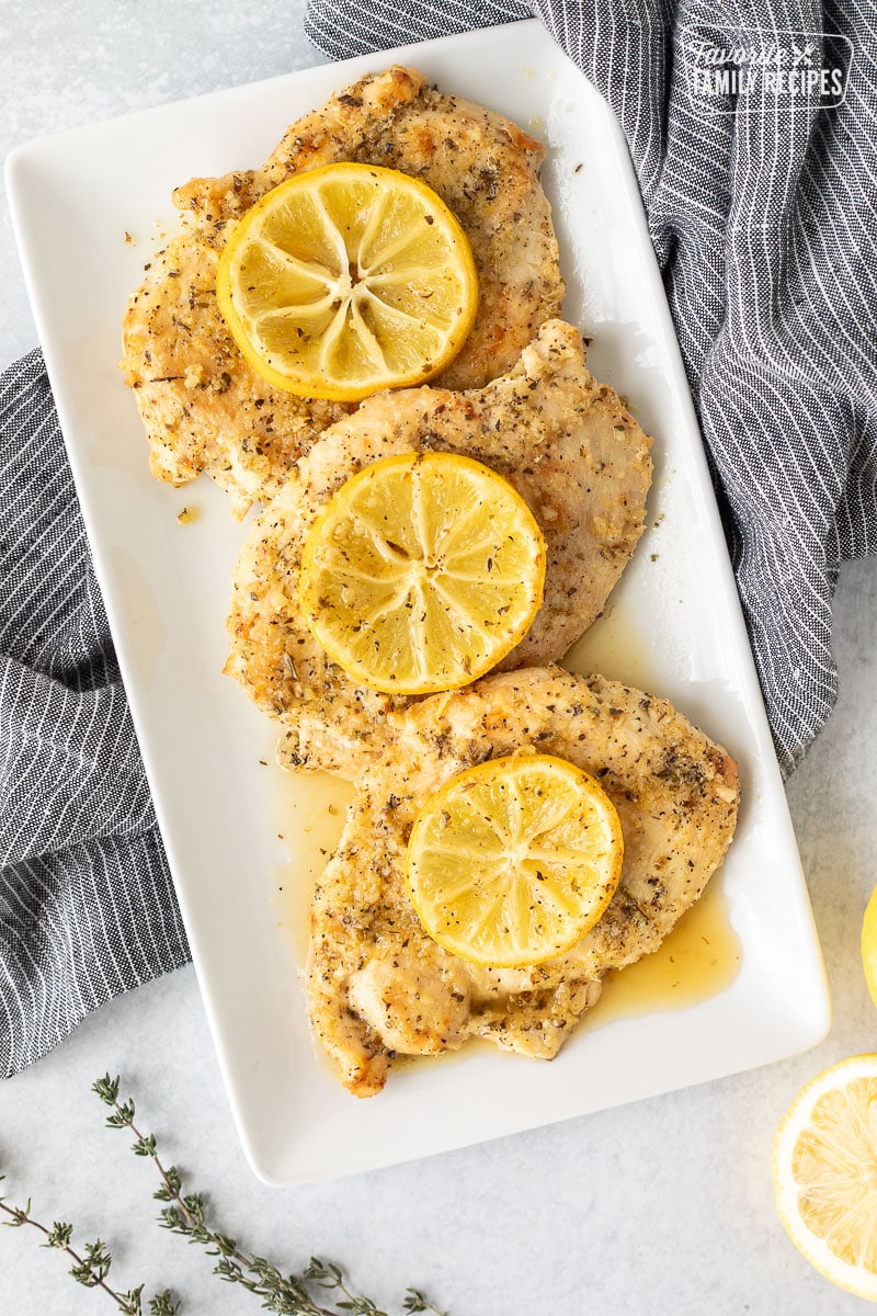 Three Baked Lemon Chicken Breasts on a dish.