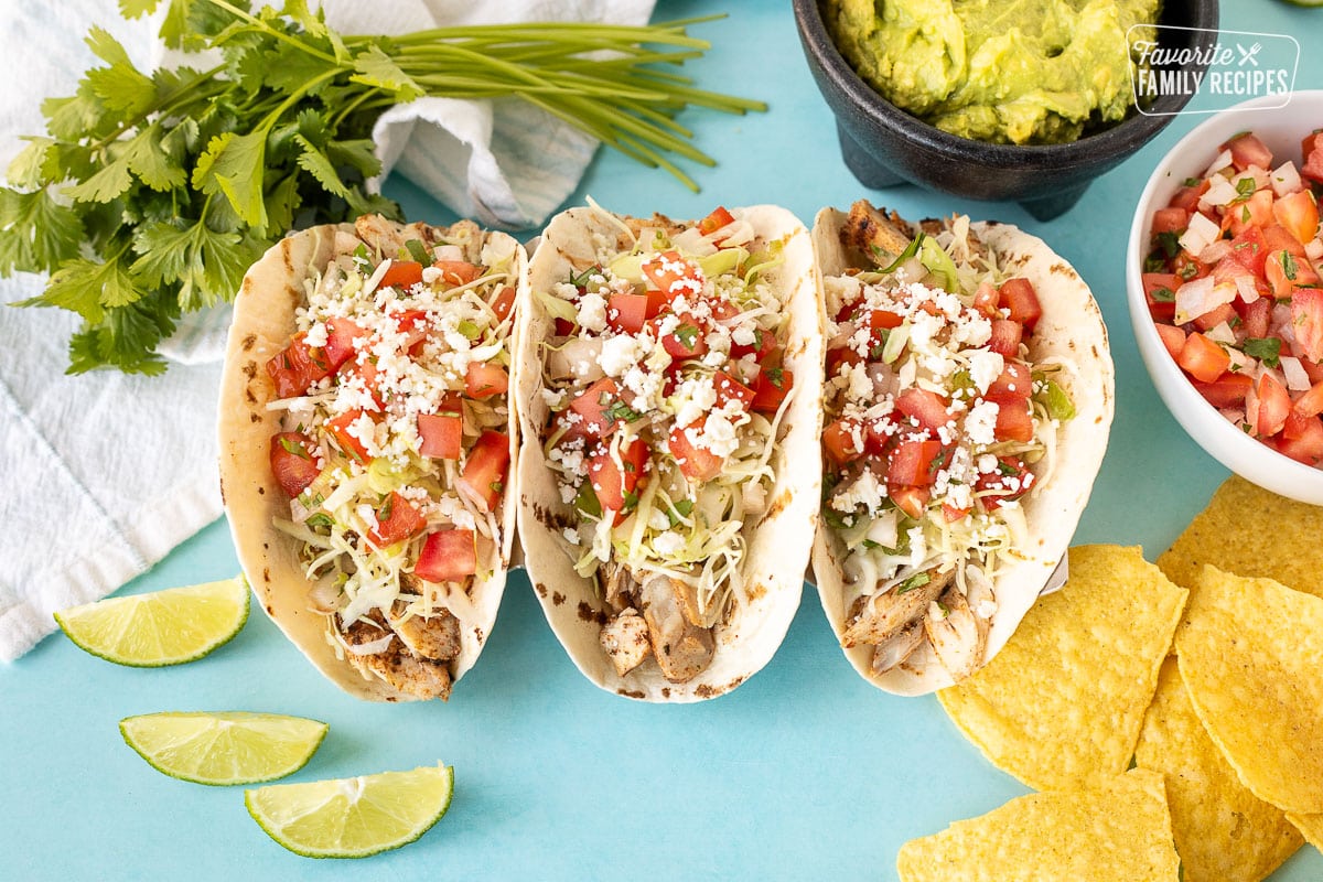 Three Grilled Mahi Mahi Tacos with cabbage, pico and cheese.