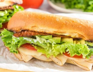 A Turkey Bacon Avocado Sandwich on a cutting board