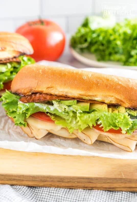 A Turkey Bacon Avocado Sandwich on a cutting board