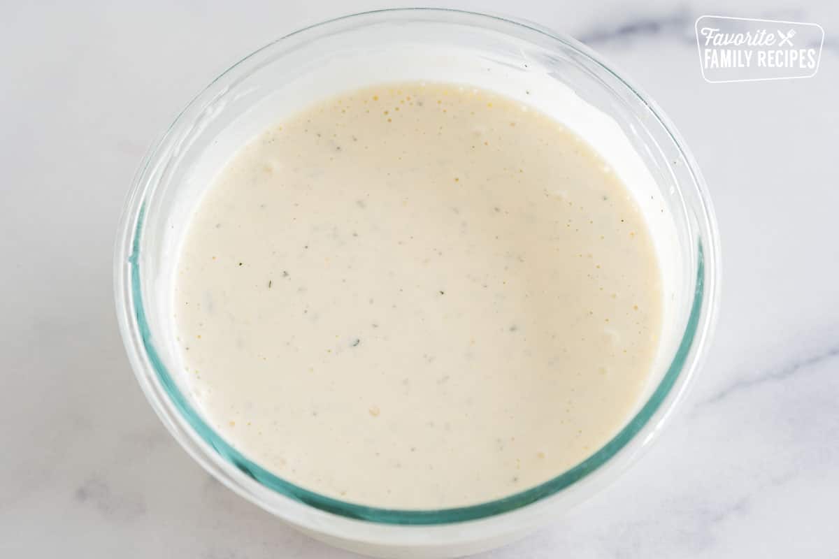 A glass bowl full of homemade ranch