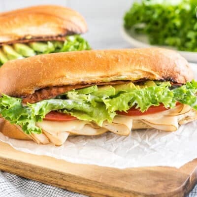 A Turkey Bacon Avocado Sandwich on a cutting board