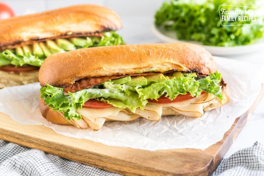 A Turkey Bacon Avocado Sandwich on a cutting board