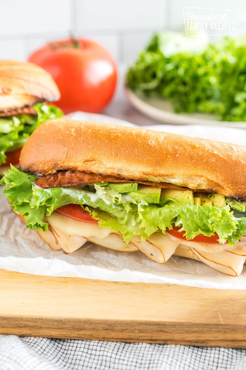 A Turkey Bacon Avocado Sandwich on a cutting board