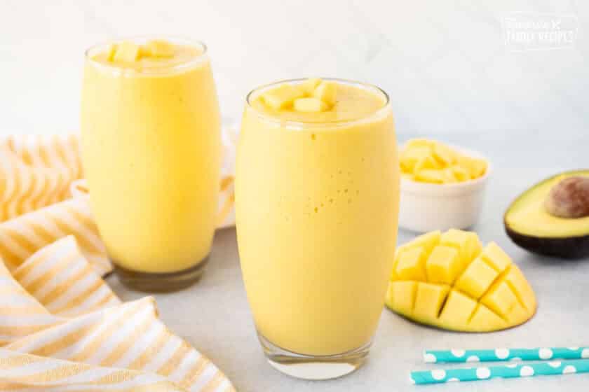 Two tall glasses of Mango Avocado Smoothie.