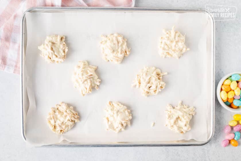 Cookie sheet with small stacks of white chocolate nests.
