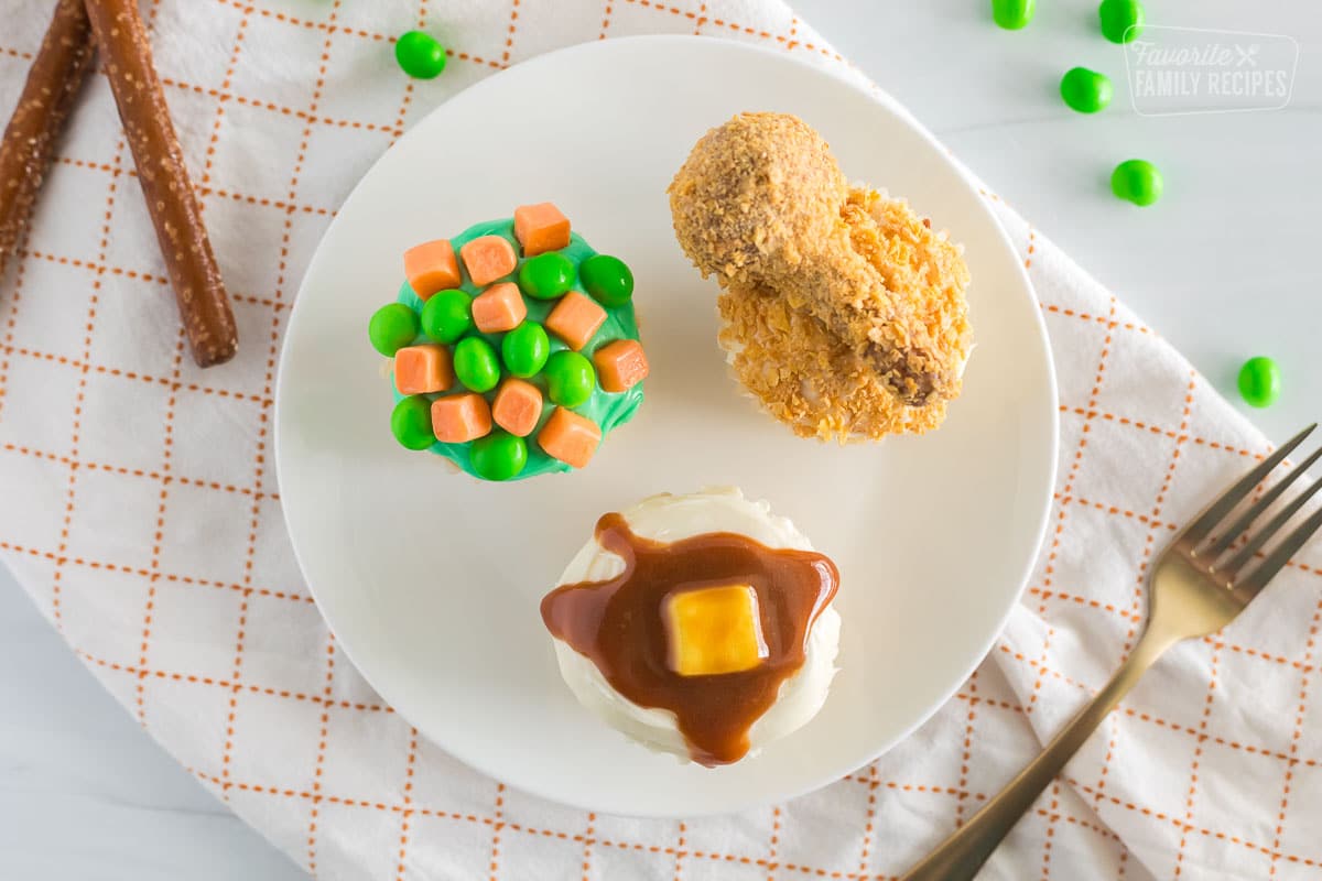 The April fools cupcakes on a white plate with a fork on the side. 