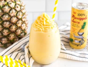 A Dole Whip in a glass with a yellow straw