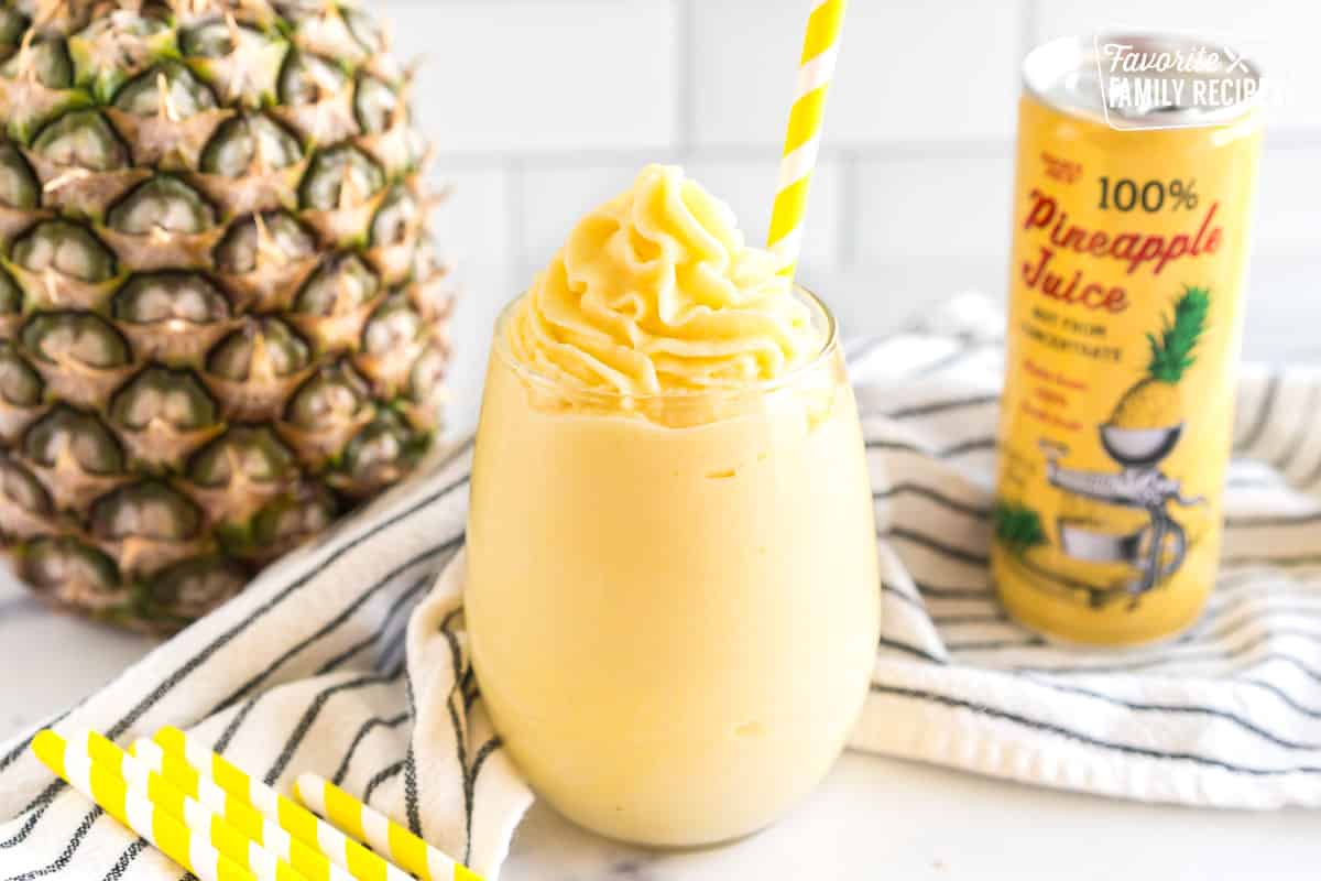 A Dole Whip in a glass with a yellow straw