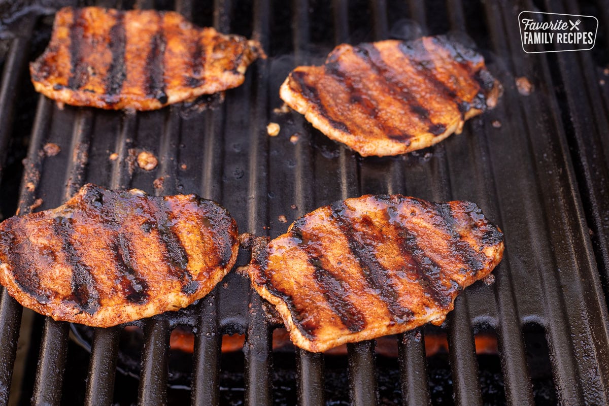 Thin pork chops on a barbecue grill.