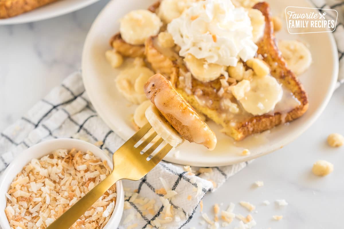 A fork taking a bite of french toast