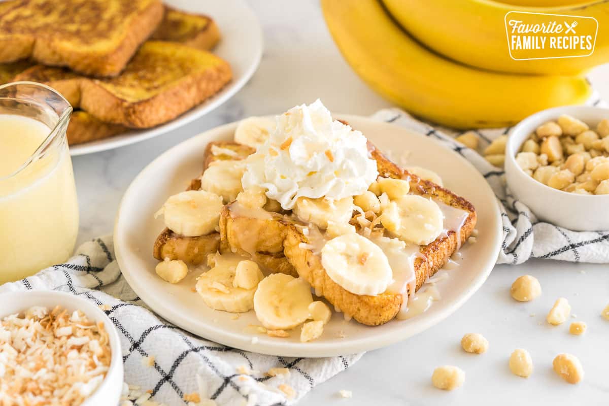 French toast topped with bananas, coconut flakes, coconut syrup, whipped cream, and macadamia nuts